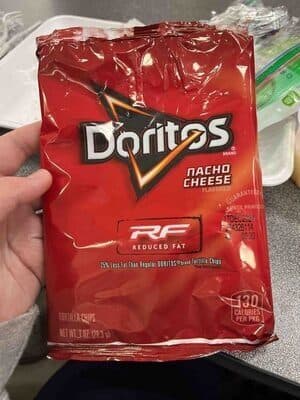 Reduced fat nacho cheese flavored tortilla chips
